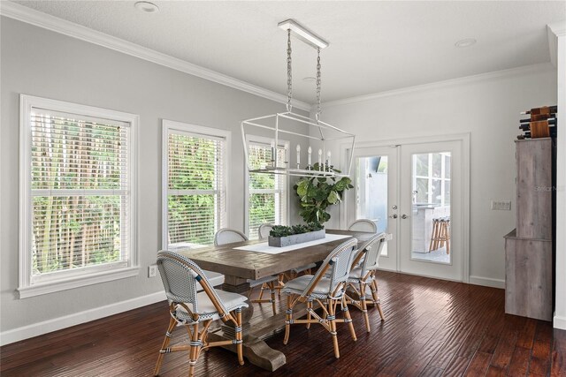 dining area with dark hardwood / wood-style floors, ornamental molding, and french doors