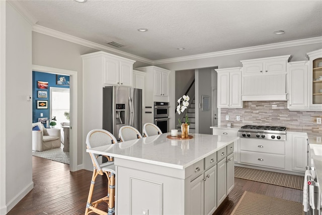 kitchen with white cabinets, stainless steel appliances, and a kitchen island