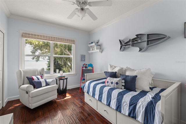 bedroom with a textured ceiling, ceiling fan, dark hardwood / wood-style flooring, and crown molding