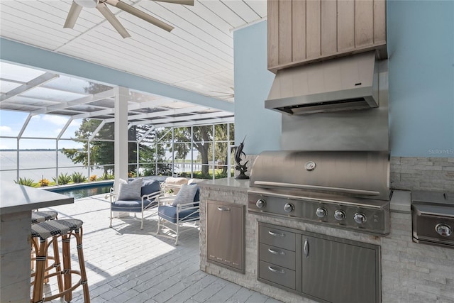 view of patio / terrace with an outdoor kitchen, an outdoor living space, a grill, and glass enclosure