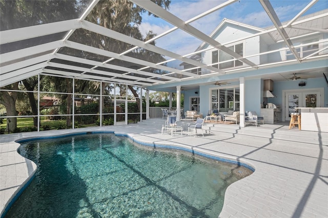 view of swimming pool featuring ceiling fan, an outdoor living space, a patio area, and glass enclosure