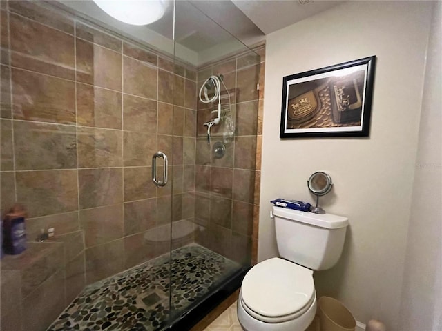 bathroom with toilet and a shower with shower door