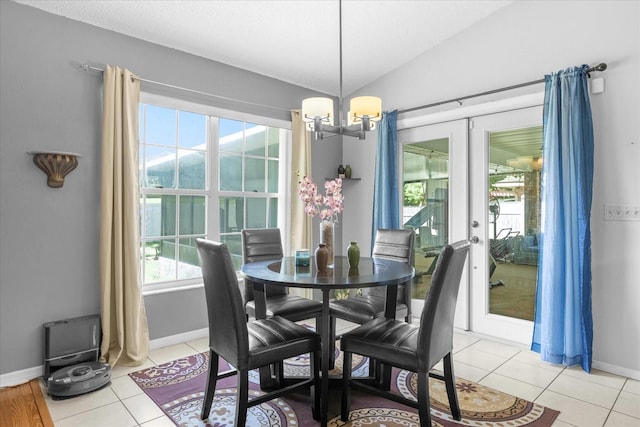 dining space with french doors, light tile patterned floors, lofted ceiling, an inviting chandelier, and baseboards