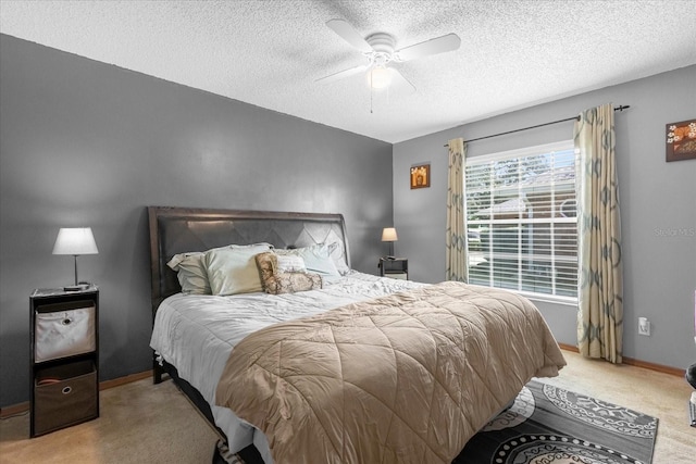 carpeted bedroom featuring ceiling fan, baseboards, and a textured ceiling