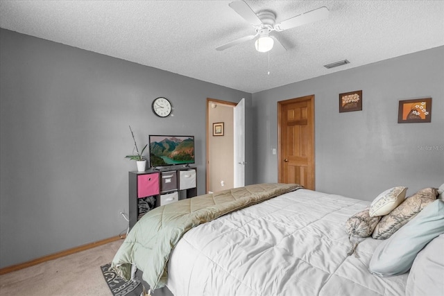 bedroom with light carpet, baseboards, visible vents, and a textured ceiling