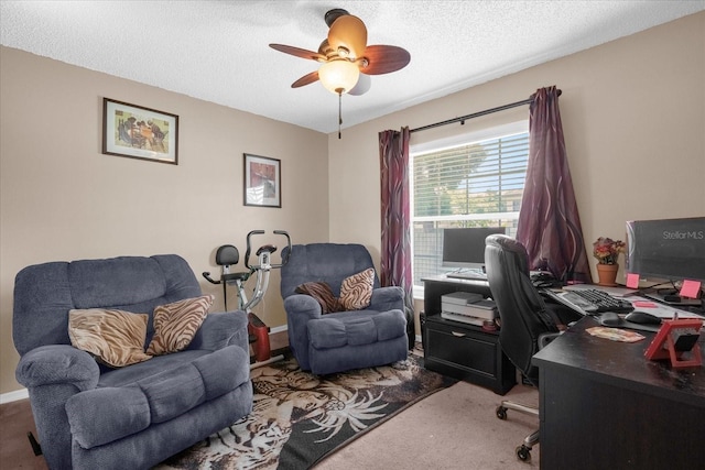 carpeted office space with a ceiling fan and a textured ceiling