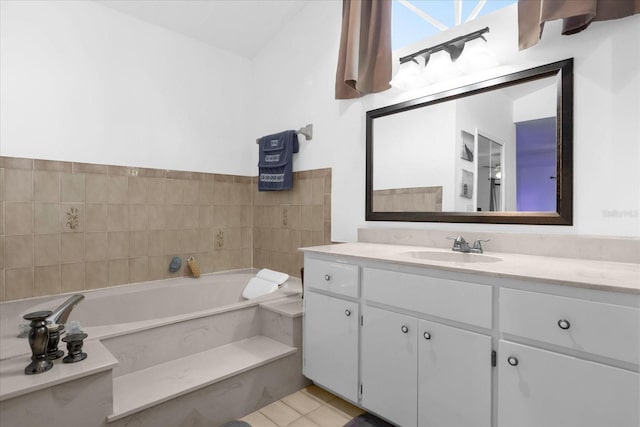 full bathroom with tile patterned floors, vanity, and a bath