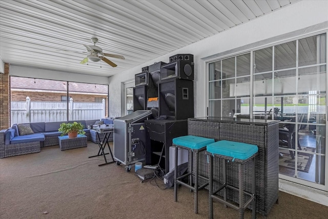 sunroom featuring a ceiling fan