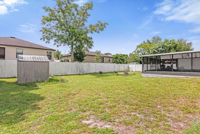 view of yard with a fenced backyard and a sunroom