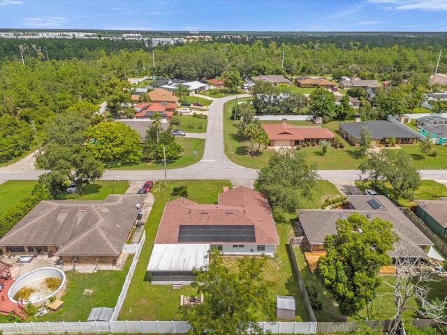 drone / aerial view featuring a forest view and a residential view