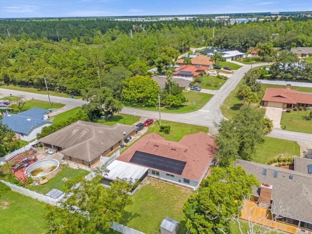 aerial view featuring a forest view and a residential view