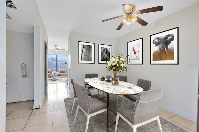 dining space with light tile patterned floors, baseboards, and visible vents