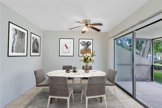 dining space featuring ceiling fan and light tile patterned flooring