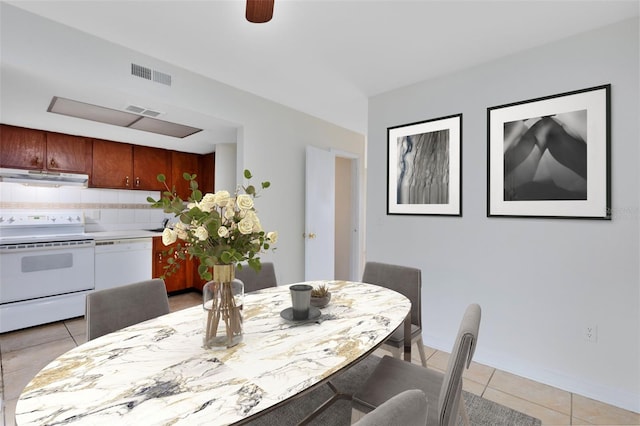 dining area featuring visible vents, baseboards, and light tile patterned floors