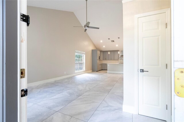 interior space featuring ceiling fan and high vaulted ceiling