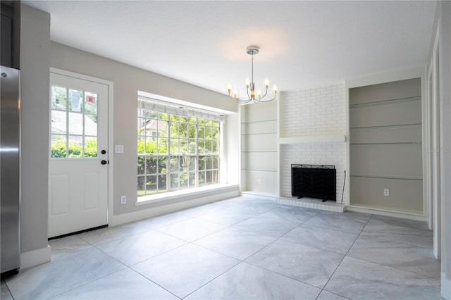 unfurnished living room featuring built in shelves, baseboards, a fireplace, and a notable chandelier