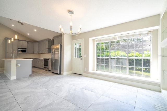 kitchen with tasteful backsplash, visible vents, lofted ceiling, appliances with stainless steel finishes, and gray cabinets