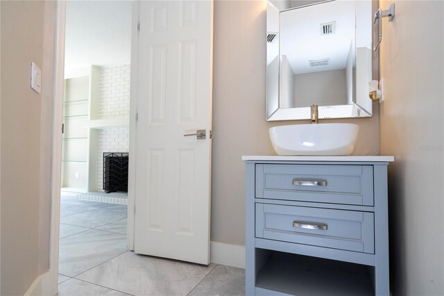 bathroom featuring vanity and a fireplace