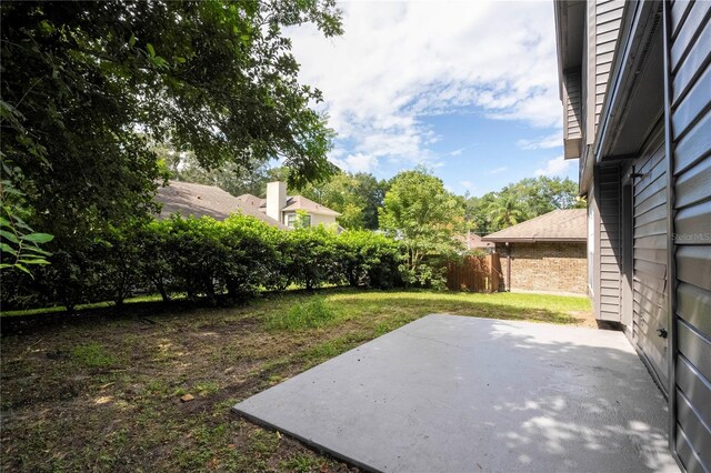 view of yard with a patio and fence