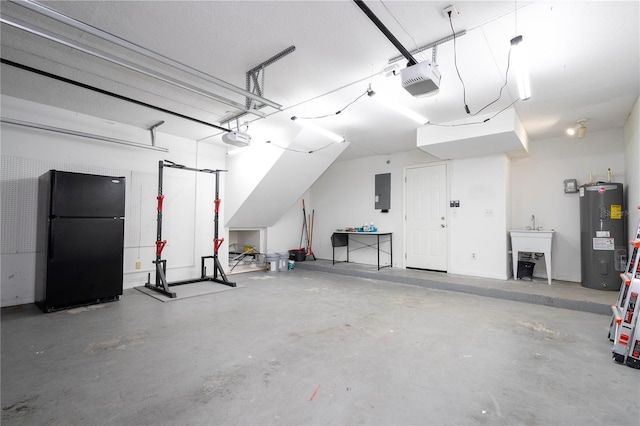 garage featuring electric panel, water heater, a garage door opener, and freestanding refrigerator