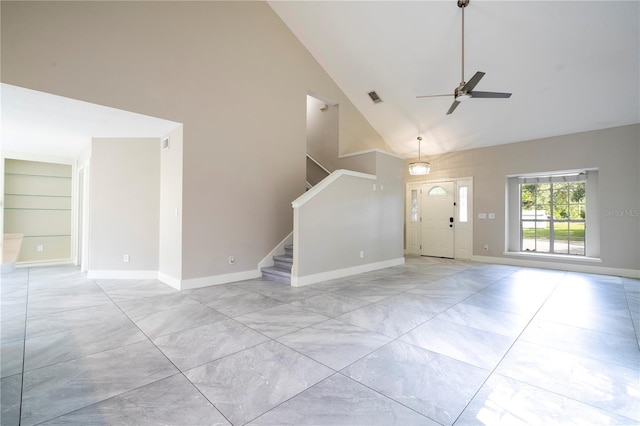 interior space featuring built in features, visible vents, high vaulted ceiling, baseboards, and stairs