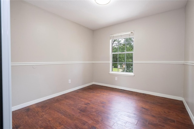 empty room with hardwood / wood-style flooring and baseboards