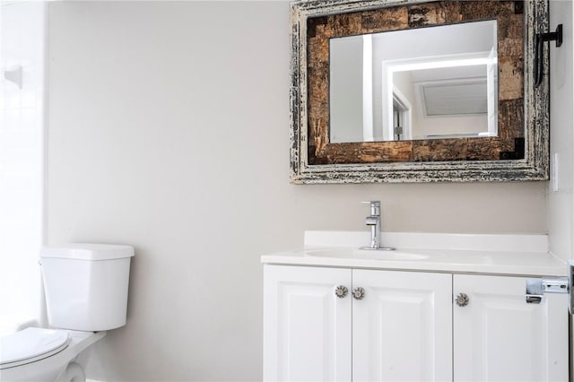 half bathroom with toilet and vanity