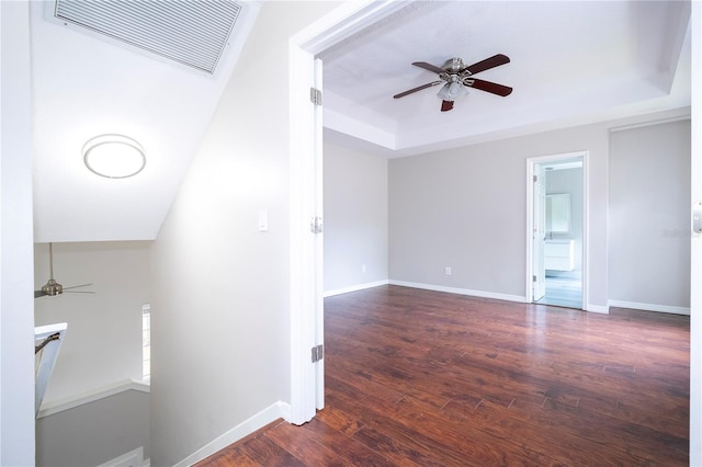 interior space featuring a tray ceiling and hardwood / wood-style floors