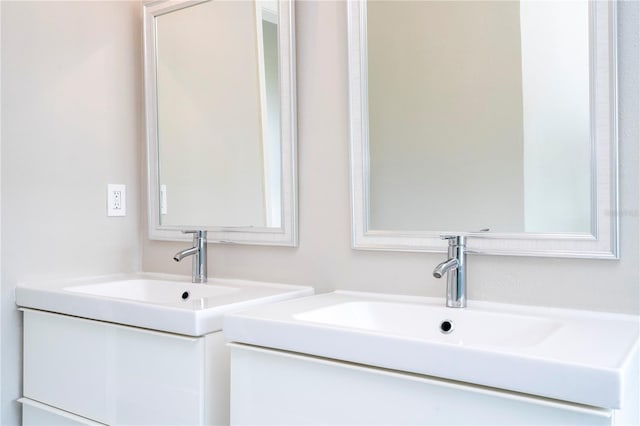 bathroom featuring two vanities and a sink