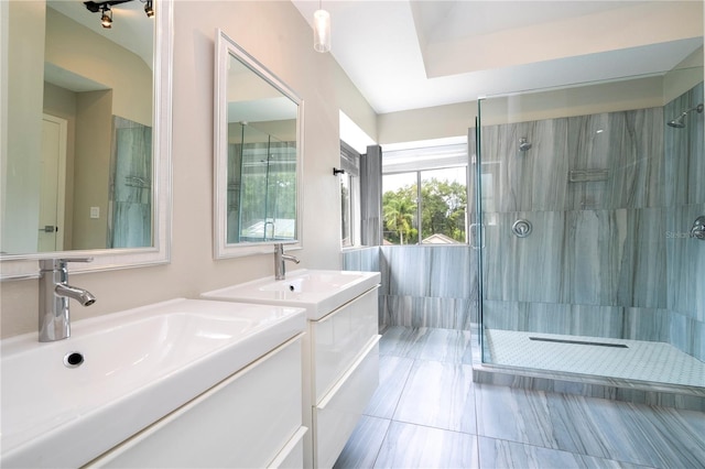 bathroom featuring vanity, tiled shower, and tile patterned flooring