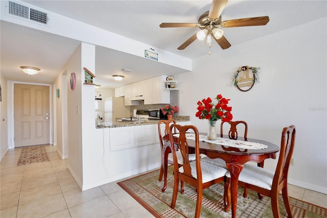 dining area with ceiling fan and light tile patterned floors