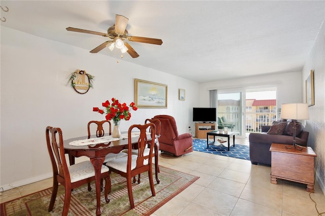 dining area with ceiling fan and light tile patterned floors