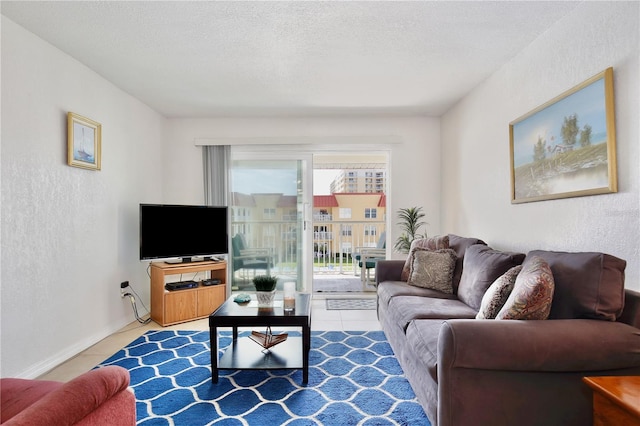 tiled living room featuring a textured ceiling