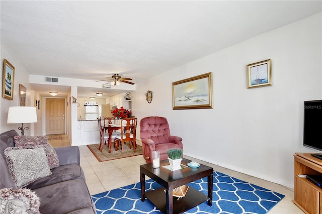 living room featuring ceiling fan and light tile patterned flooring