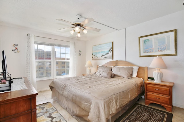 tiled bedroom with ceiling fan