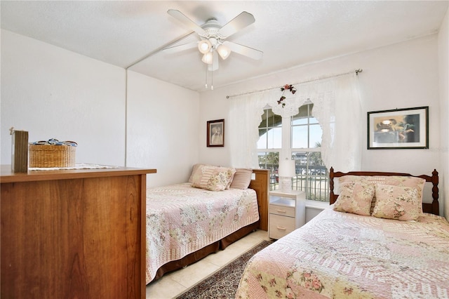 tiled bedroom with ceiling fan