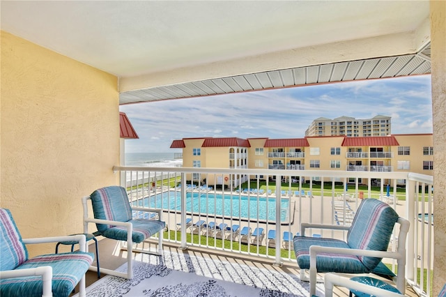 balcony featuring a community pool