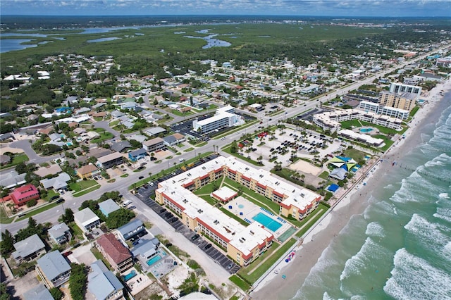 drone / aerial view featuring a beach view and a water view