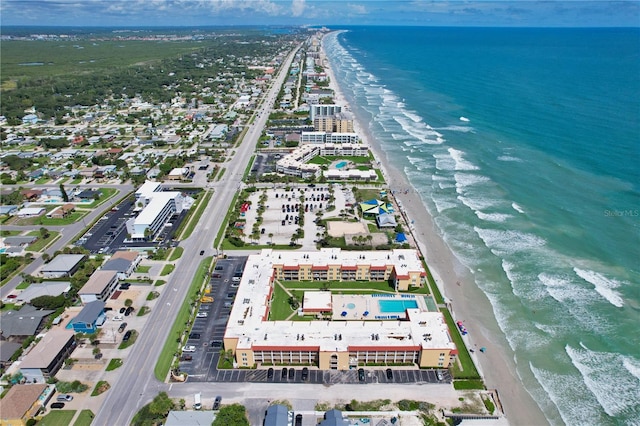 drone / aerial view featuring a beach view and a water view