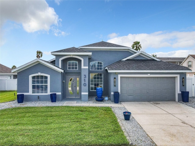 view of front of property featuring a front yard, roof with shingles, stucco siding, a garage, and driveway