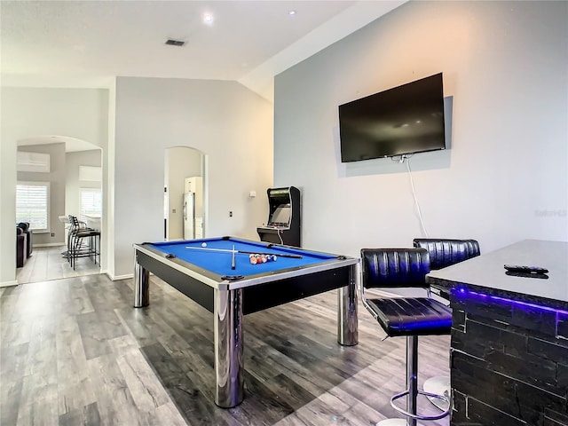 recreation room with wood finished floors, visible vents, arched walkways, pool table, and vaulted ceiling