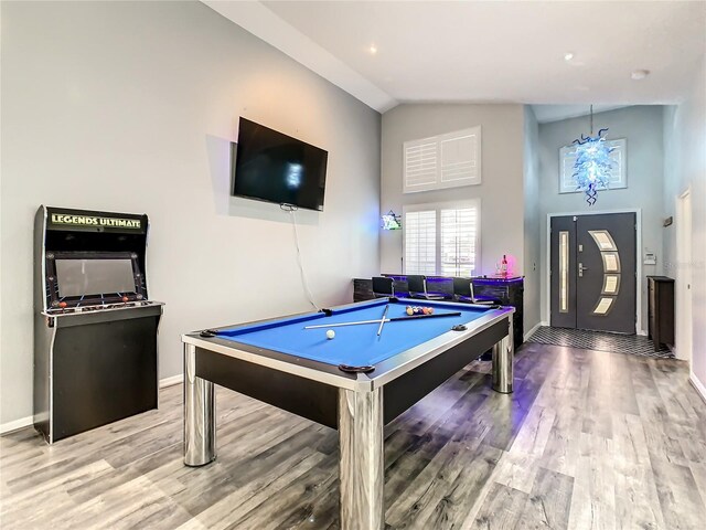 recreation room with lofted ceiling, billiards, and hardwood / wood-style floors