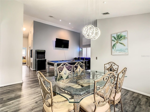 dining room featuring dark hardwood / wood-style flooring and a notable chandelier