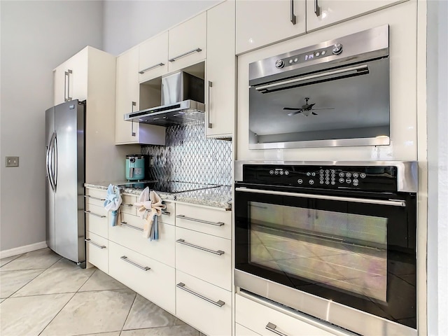 kitchen with appliances with stainless steel finishes, extractor fan, tasteful backsplash, white cabinetry, and ceiling fan