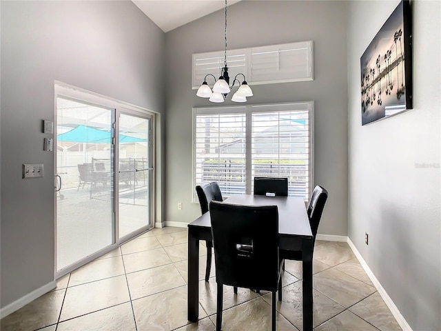 dining room with high vaulted ceiling, a chandelier, and light tile patterned flooring