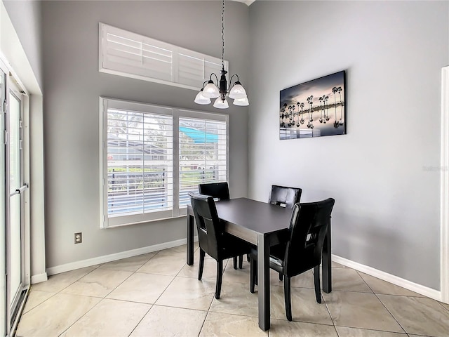 dining room with light tile patterned floors, baseboards, and a chandelier