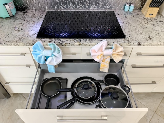 interior details featuring black electric stovetop and tile patterned flooring