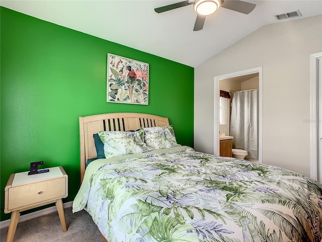 bedroom featuring visible vents, ceiling fan, carpet, vaulted ceiling, and ensuite bathroom