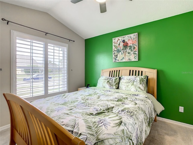 carpeted bedroom featuring a ceiling fan, baseboards, and vaulted ceiling