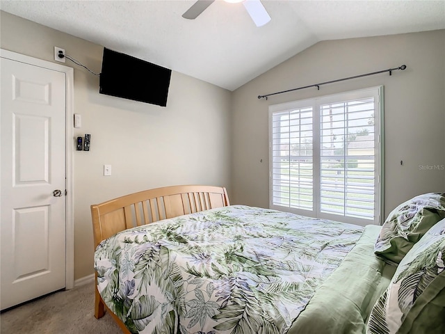 bedroom featuring lofted ceiling, carpet, and ceiling fan